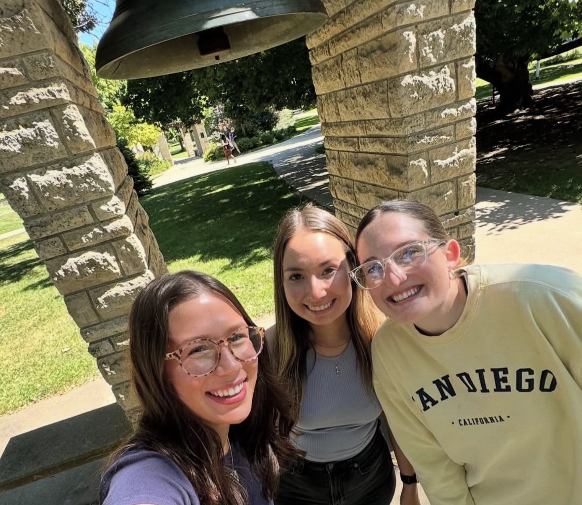 Transfer student Liz Clement ('26) poses in front of the Luther Bell with Makenzie Dahlstrom ('25) and Emilee Burcham-Scofield ('26). Photo courtesy of Clement.